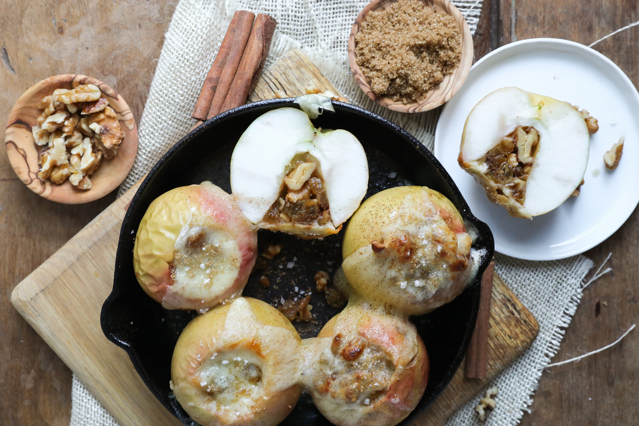 Cheddar Raisin Walnut Baked Apples | JennySheaRawn.com An overhead image of a skillet of baked apples