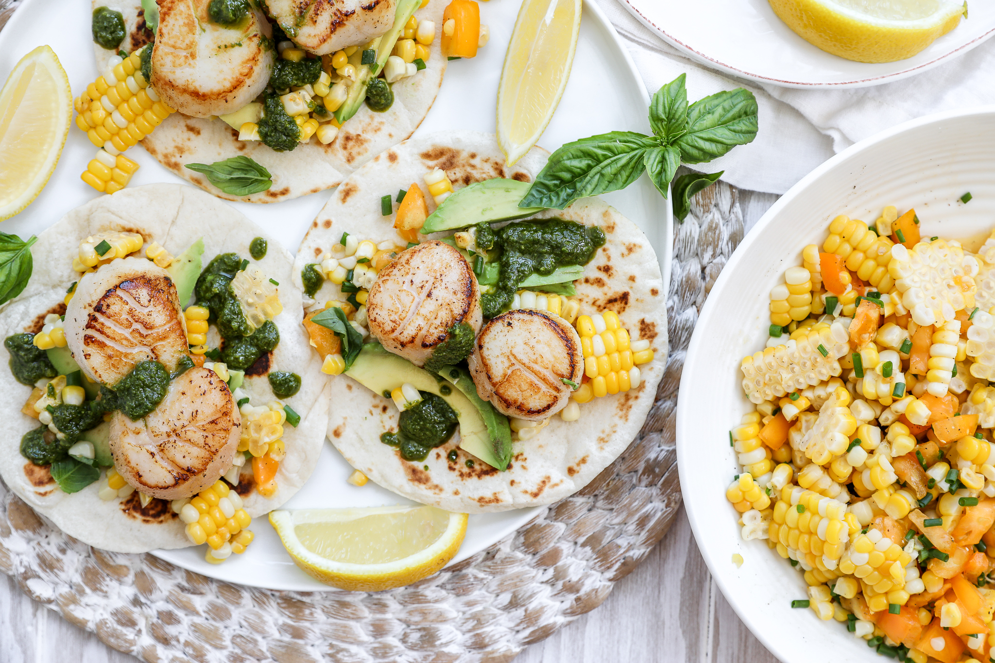 Seared Scallops with Corn Salsa -04 an overhead image of scallop tacos with basil oil