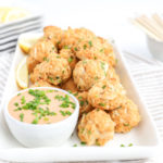 crab cakes bites on a plate with thousand island dressing