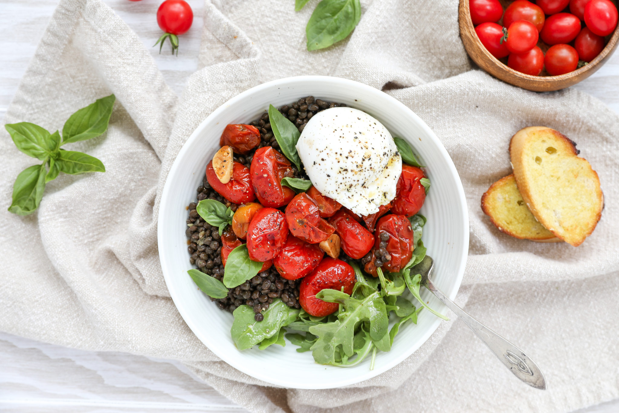 Black Lentils with Garlicky Roasted Tomatoes and Burrata an overhead shot of lentils with roasted tomatoes and burrata